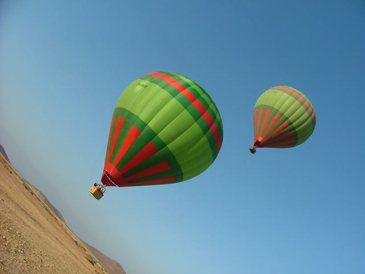 Colourful hot air balloons floating over the arid plains near Marrakech