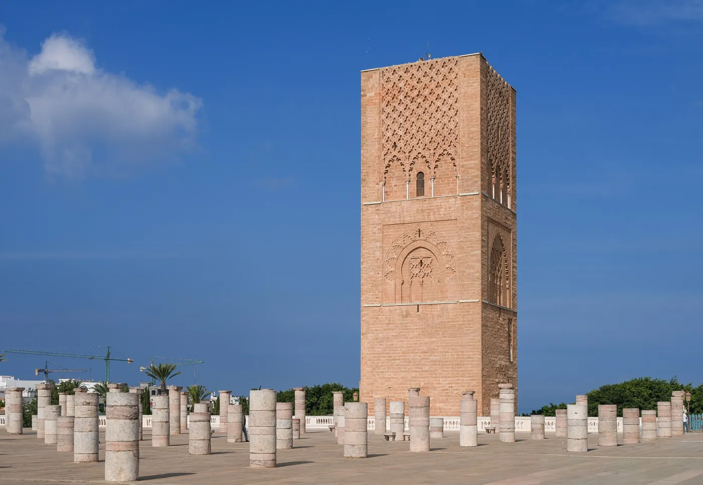 The unfinished sandstone Hassan Tower in Rabat rising above rows of broken marble columns on a sunny day