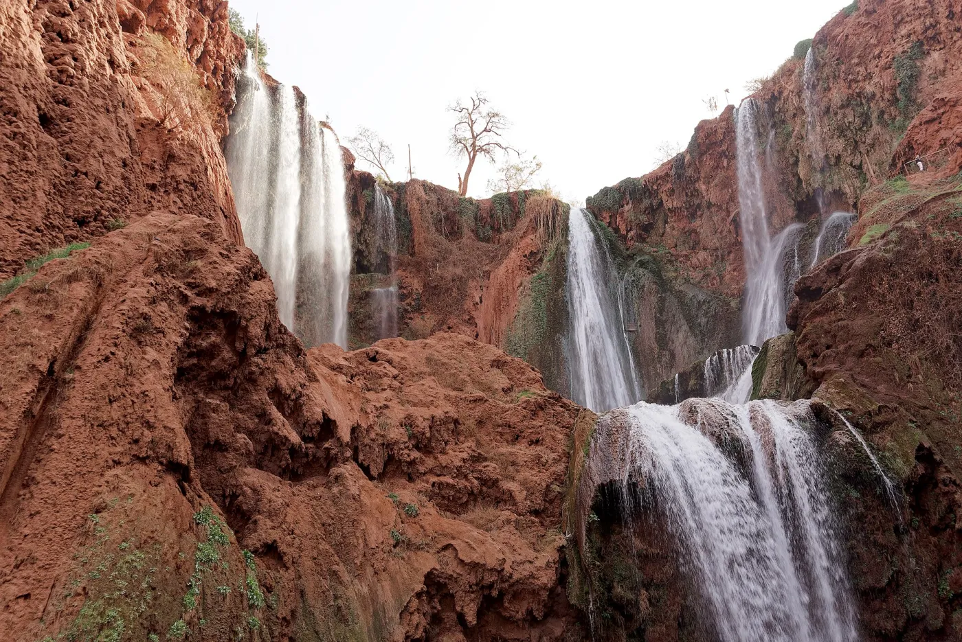 Ouzoud Waterfalls cascading in three tiers into a green gorge with a rainbow in the spray, Azilal, Morocco